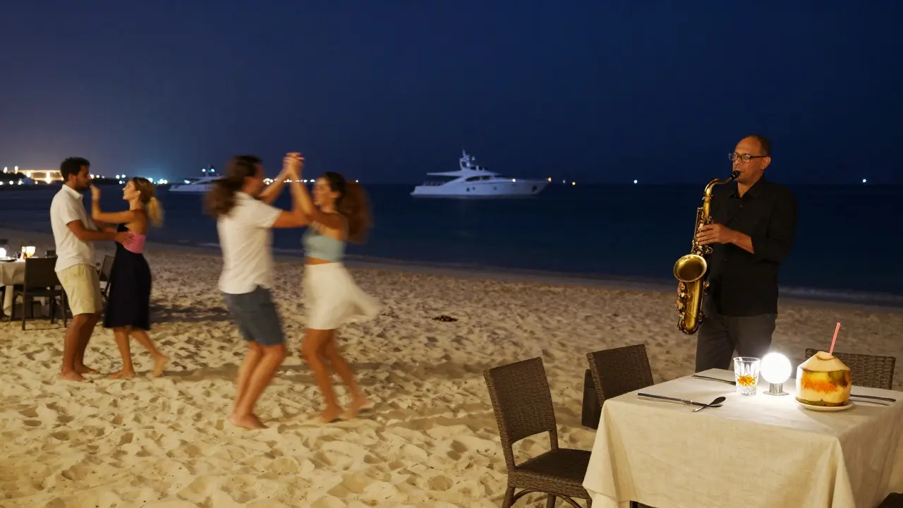 People dancing barefoot on a beach at night under stars, with a saxophonist playing and yachts lit up on the water.